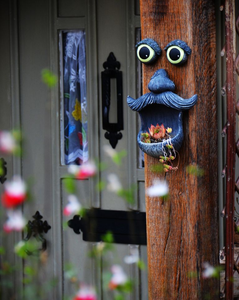 Funny post character hanging in home in Lower Slaughter, Cotswolds England