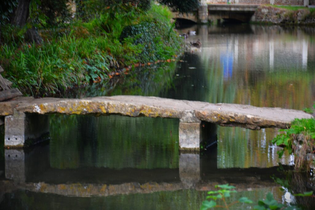 Narrow bridge over stream in Lower Slaughter, Cotswolds England